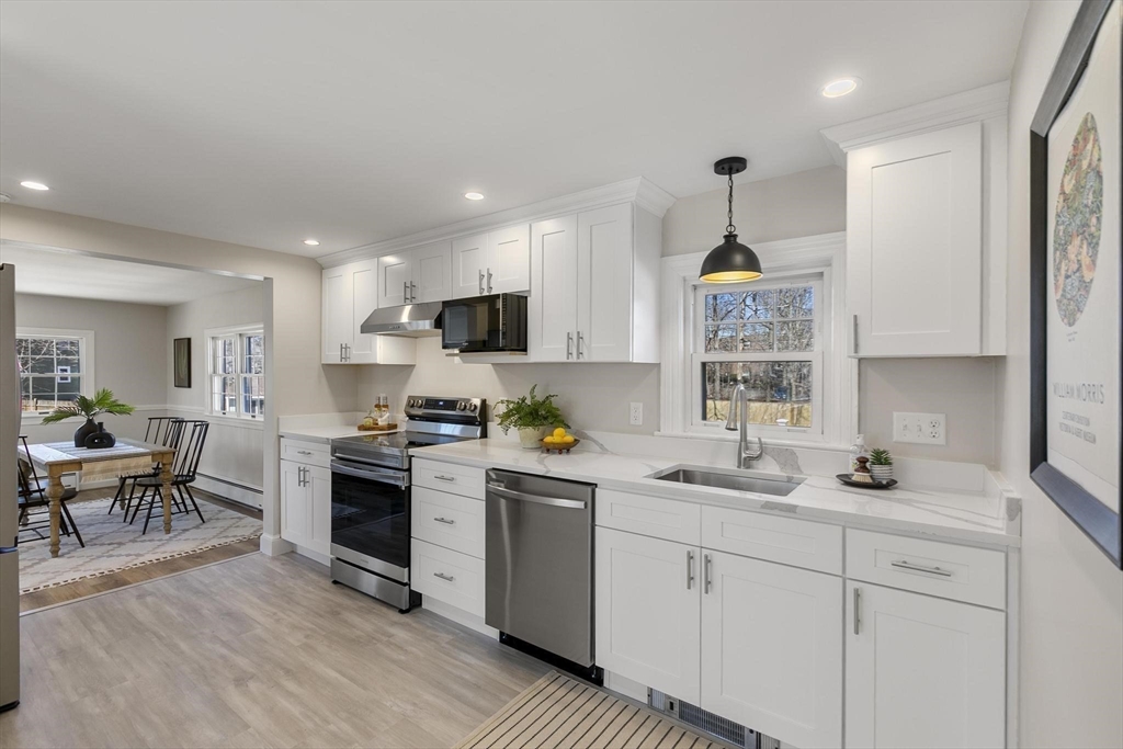 8 Crosby Road Reading, MA 01867 - Photo 11 of 30 a kitchen with a sink a window stainless steel appliances and cabinets