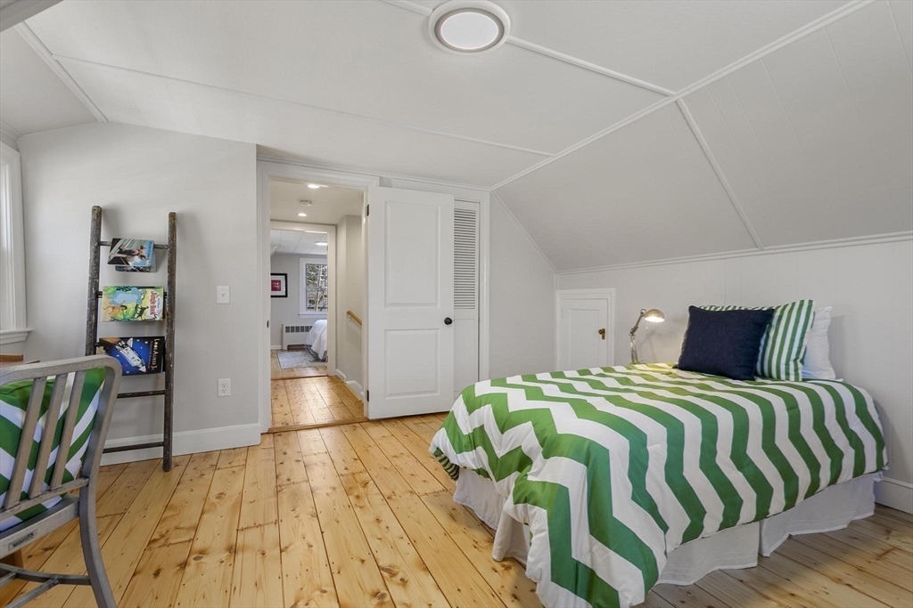 8 Crosby Road Reading, MA 01867 - Photo 18 of 30 a bedroom with a bed and a book shelf