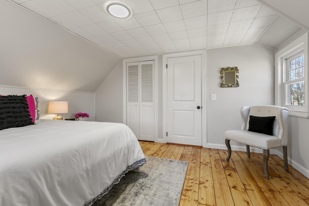 8 Crosby Road Reading, MA 01867 - Photo 21 of 30 a bedroom with a bed and a table in it