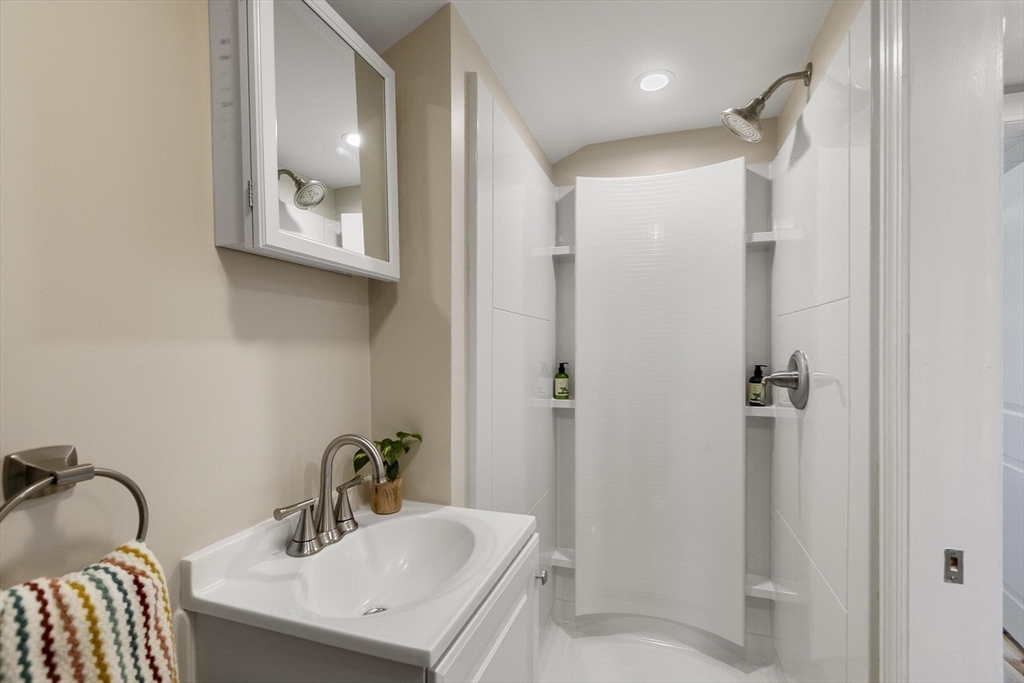 8 Crosby Road Reading, MA 01867 - Photo 22 of 30 a bathroom with a sink and mirror