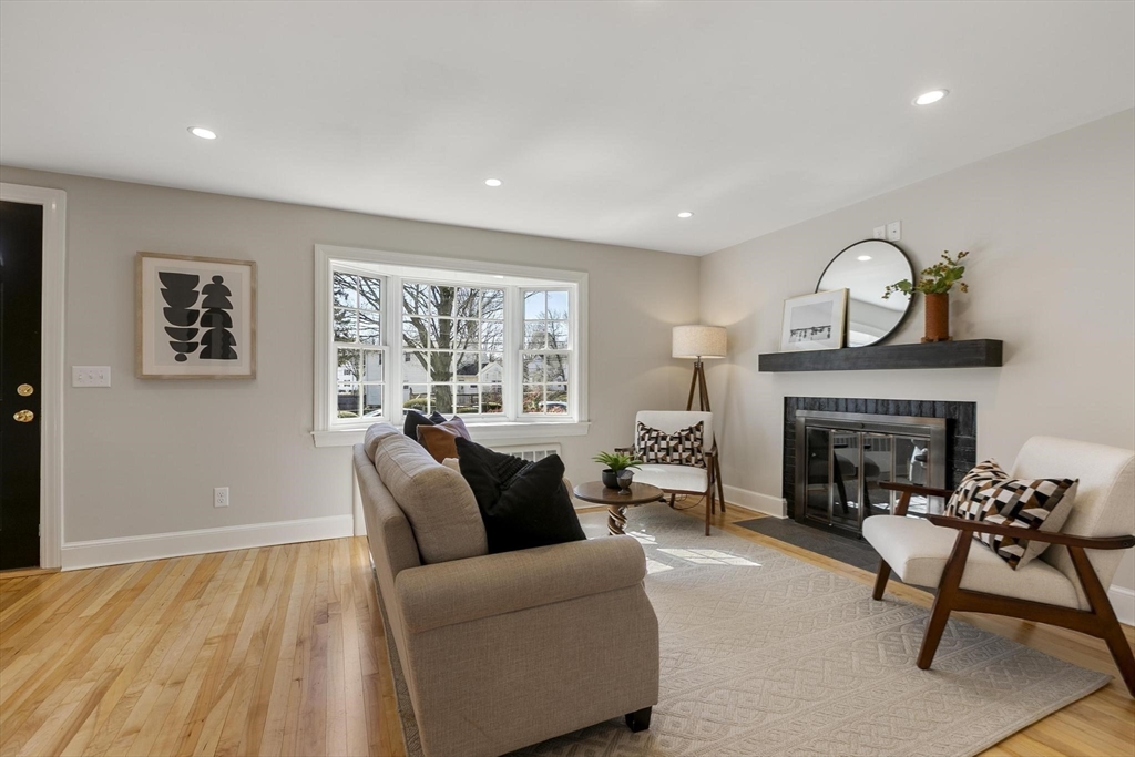 8 Crosby Road Reading, MA 01867 - Photo 6 of 30 a living room with furniture and a fireplace