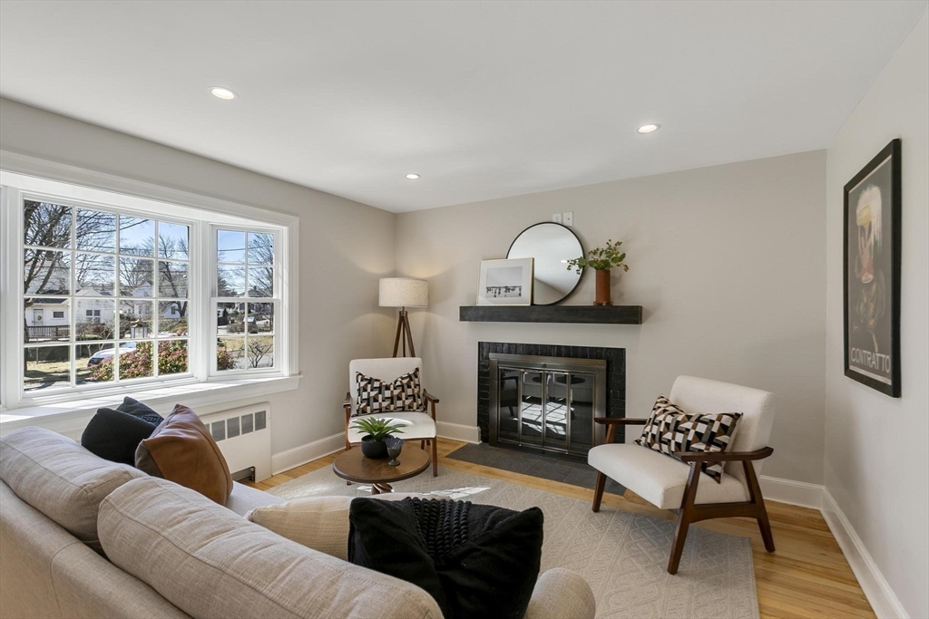 8 Crosby Road Reading, MA 01867 - Photo 7 of 30 a living room with furniture and a fireplace