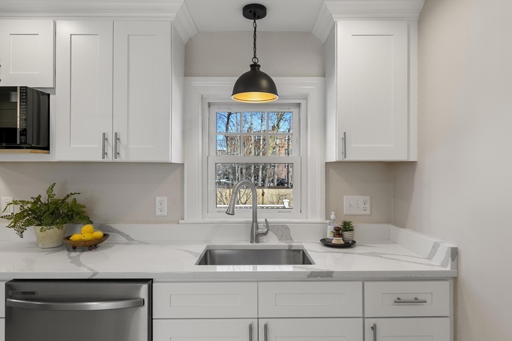 8 Crosby Road Reading, MA 01867 - Photo 9 of 30 a kitchen with a sink and cabinets