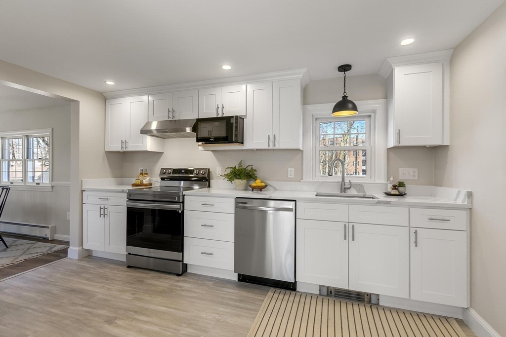8 Crosby Road Reading, MA 01867 - Photo 10 of 30 a kitchen with stainless steel appliances a sink stove and refrigerator