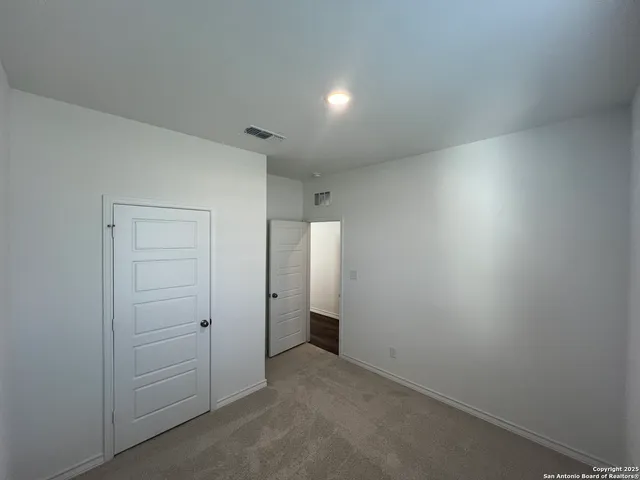 an empty room with an entrance and shower