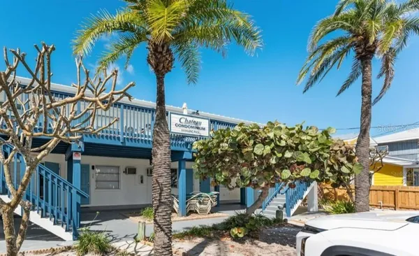a view of a house with a tree in the background