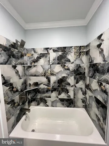 an empty room with wooden floor and entrance