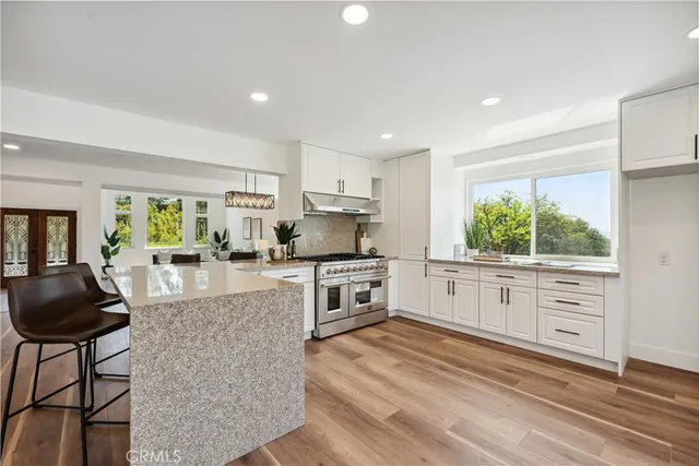 a kitchen with stainless steel appliances granite countertop a stove and cabinets