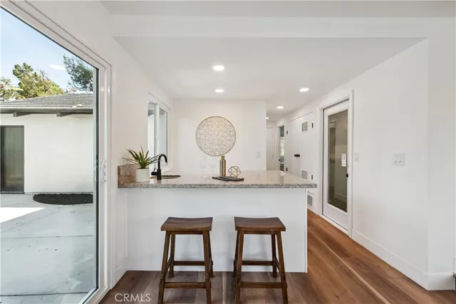a living room with furniture ceiling fan and a large window