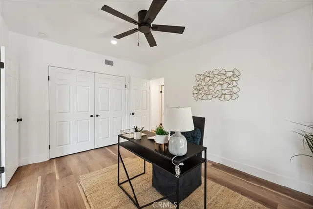 a view of a room with wooden floor and white walls