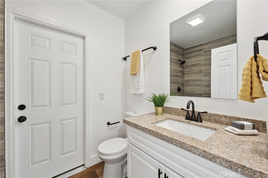 529 Manzanita Road Redlands, CA 92373 - Photo 34 of 64 a bathroom with a granite countertop sink and a mirror