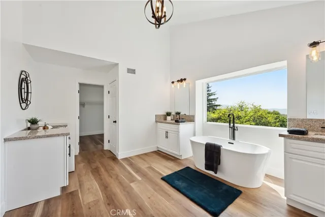 a view of empty room with window and ceiling fan