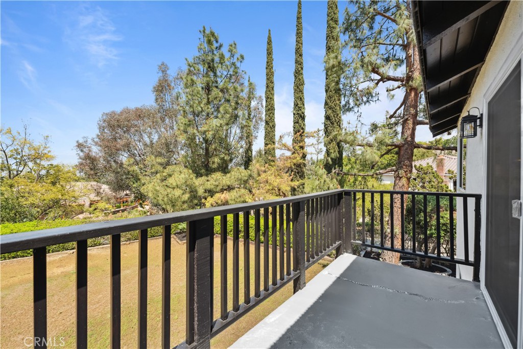 529 Manzanita Road Redlands, CA 92373 - Photo 47 of 64 a view of a balcony with wooden floor and fence