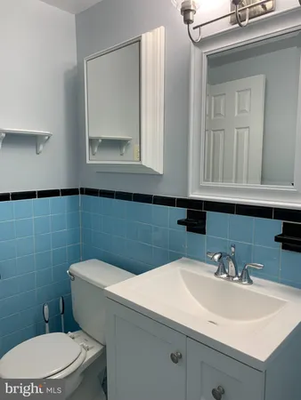 a bathroom with a sink a toilet and mirror