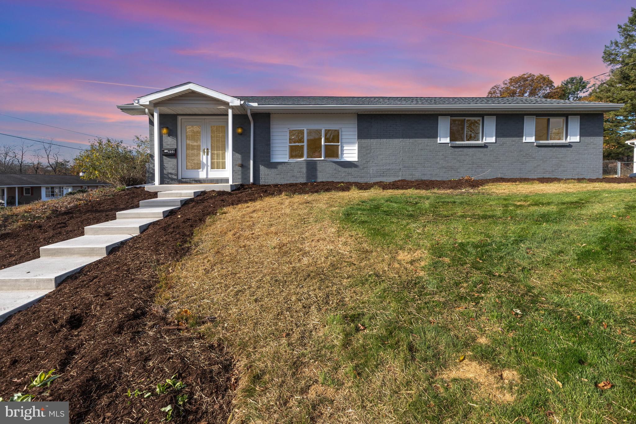 a front view of a house with a yard