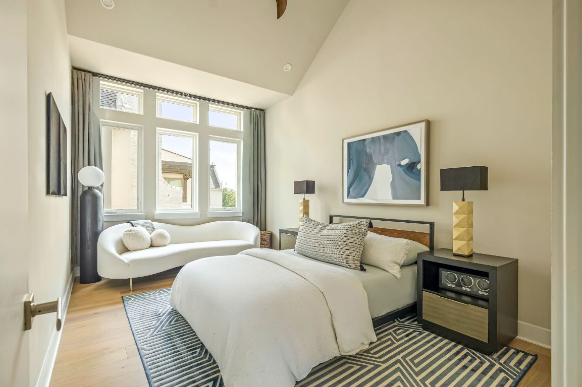 2300 Enfield Road, Unit 302 Austin, TX 78703 - Photo 11 of 26 a bedroom with a bed a couch and large window