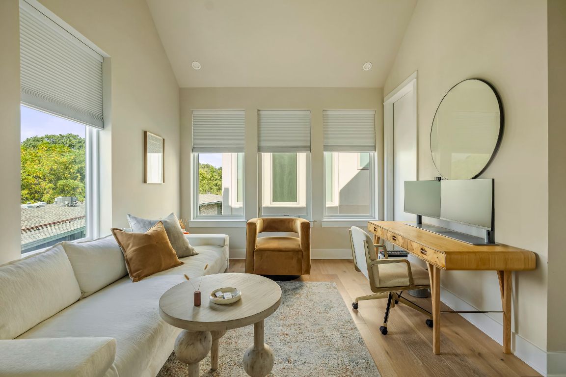 2300 Enfield Road, Unit 302 Austin, TX 78703 - Photo 16 of 26 a living room with furniture a table and a large window
