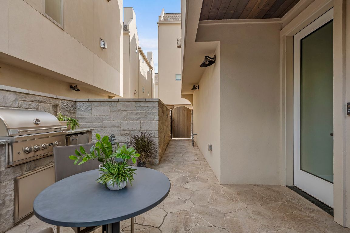 2300 Enfield Road, Unit 302 Austin, TX 78703 - Photo 22 of 26 a kitchen with a table and chairs