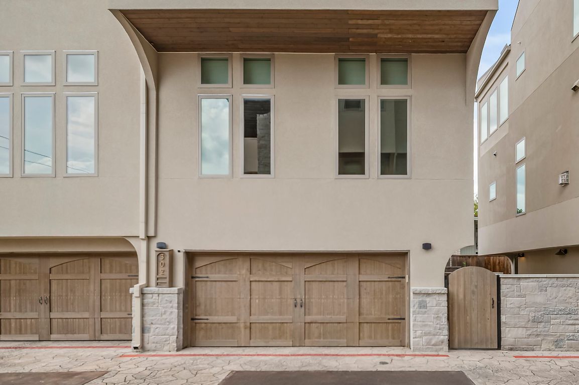 2300 Enfield Road, Unit 302 Austin, TX 78703 - Photo 23 of 26 a front view of a house with parking