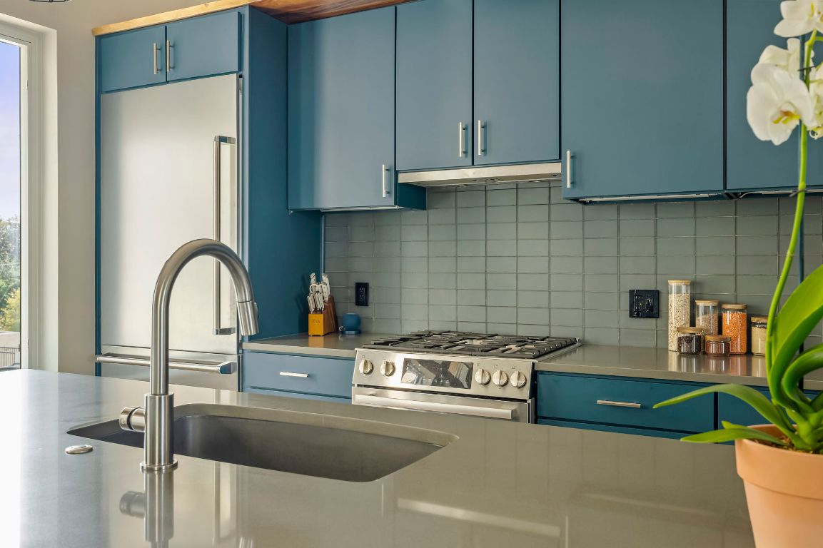 2300 Enfield Road, Unit 302 Austin, TX 78703 - Photo 7 of 26 a kitchen with stainless steel appliances granite countertop a sink a stove and a wooden cabinets