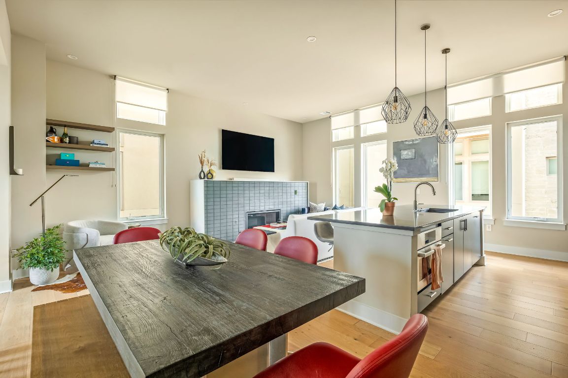 2300 Enfield Road, Unit 302 Austin, TX 78703 - Photo 8 of 26 a kitchen with a stove a sink and a flat screen tv
