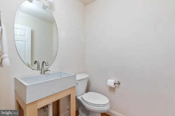 a kitchen with stainless steel appliances granite countertop a stove top oven a sink a dining table and chairs