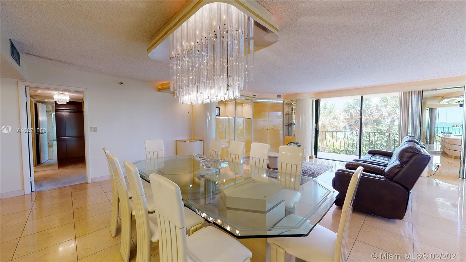 Normandy Beach Surfside, FL 33154 - Photo 13 of 18 a living room with furniture and a chandelier