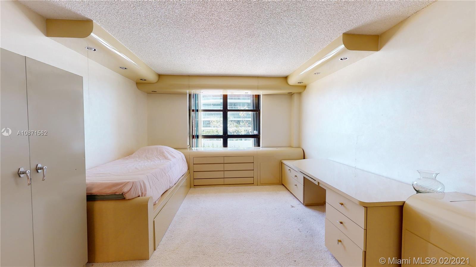 Normandy Beach Surfside, FL 33154 - Photo 15 of 18 a bedroom with a bed and a window