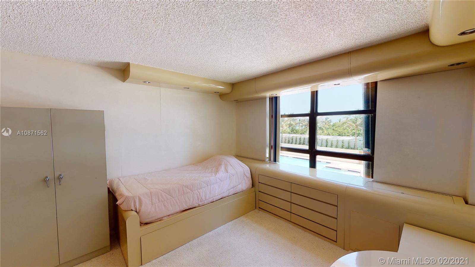 Normandy Beach Surfside, FL 33154 - Photo 17 of 18 a bedroom with a bed and a window