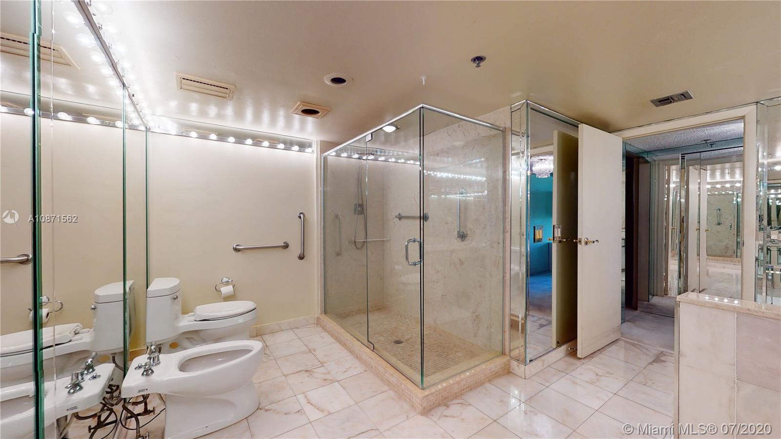 Normandy Beach Surfside, FL 33154 - Photo 6 of 18 a bathroom with a glass shower door and a sink