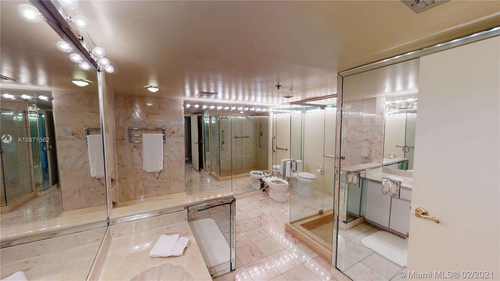 Normandy Beach Surfside, FL 33154 - Photo 7 of 18 a bathroom with a double vanity sink mirror and shower