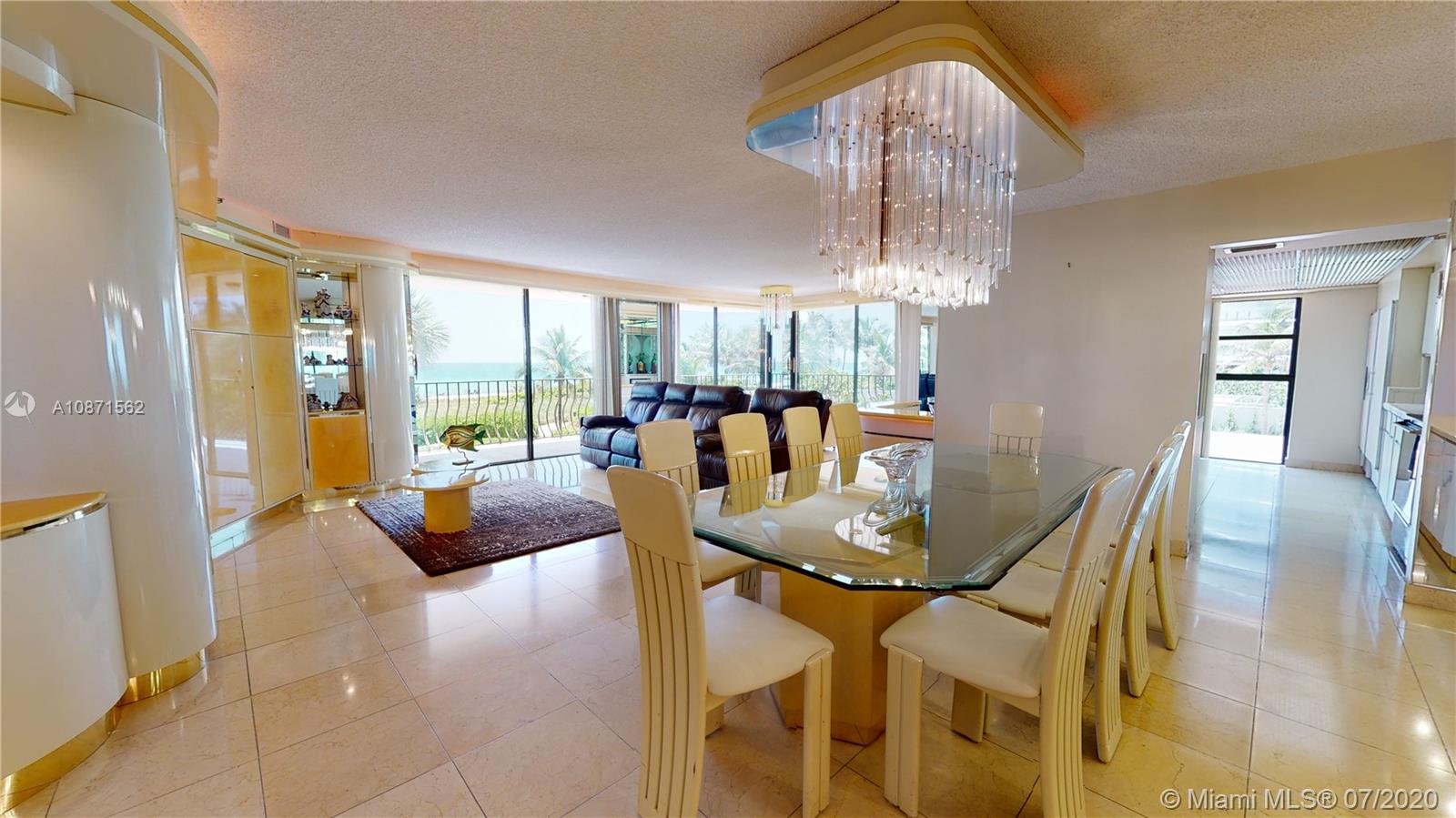 Normandy Beach Surfside, FL 33154 - Photo 8 of 18 a dining room with furniture a chandelier and wooden floor