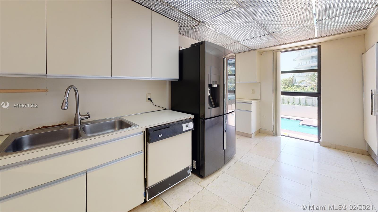 Normandy Beach Surfside, FL 33154 - Photo 9 of 18 a kitchen with stainless steel appliances granite countertop a refrigerator and a sink