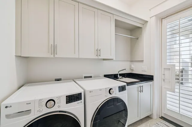 a bedroom with a bed dresser and a large window