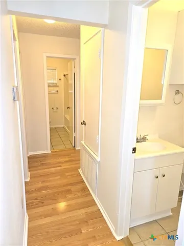 a view of a bathroom from a hallway