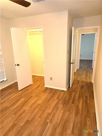 a view of a room with wooden floor