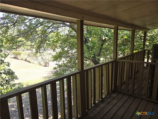 a view of a balcony with wooden floor