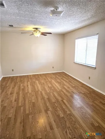 a view of room with window and hardwood floor
