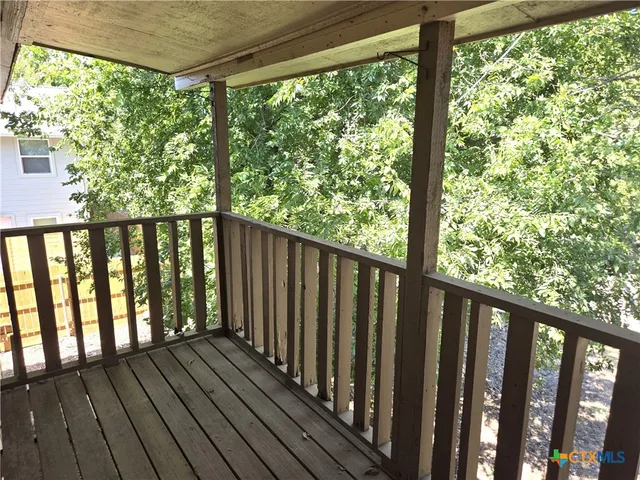 a view of wooden balcony with outdoor space