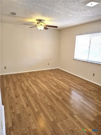 a view of a room with wooden floor