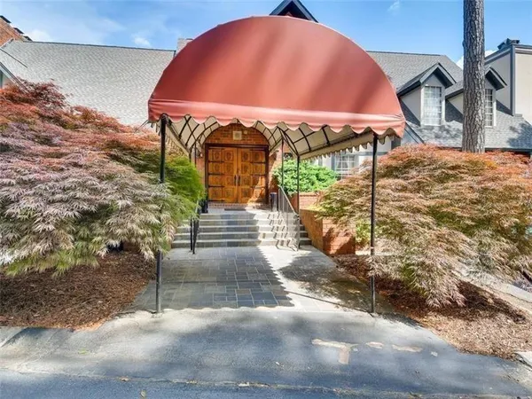 a view of a house with a yard and sitting area