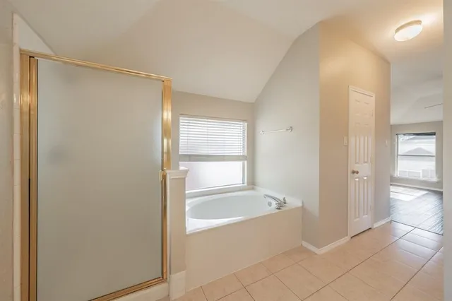 a spacious bathroom with a bathtub and a shower