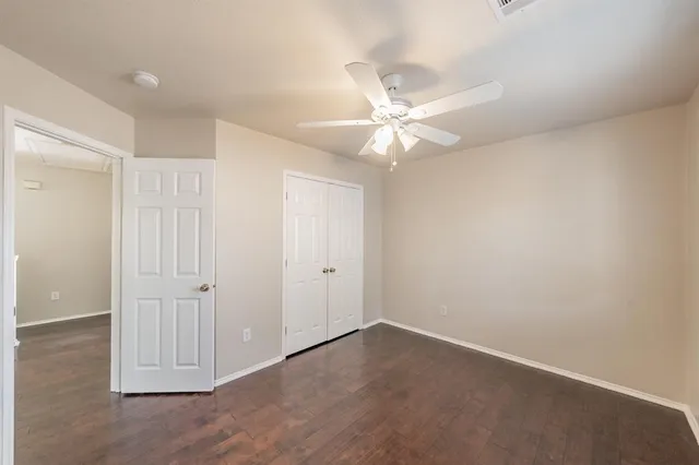 an empty room with fan and a ceiling fan
