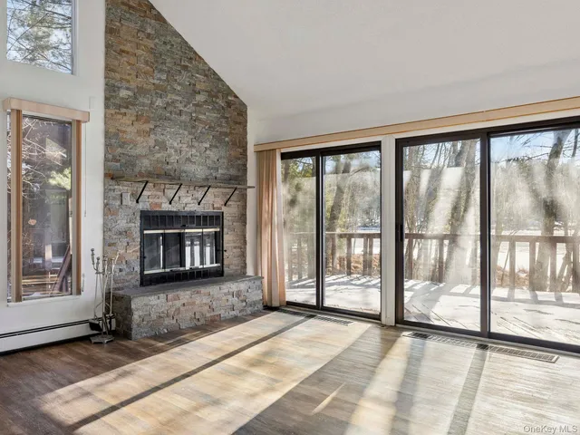 a view of an empty room with glass door and balcony