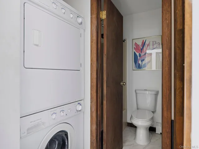 a white toilet sitting next to a bathroom sink