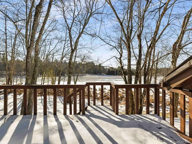a view of wooden balcony with trees