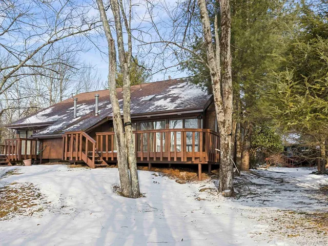 a view of a house with a yard covered in snow