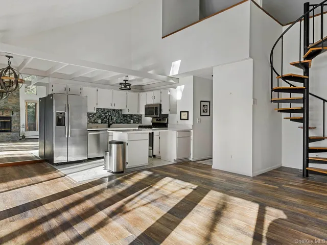 a kitchen with a refrigerator and a stove top oven