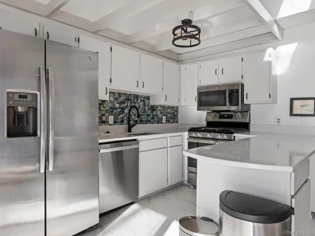 a kitchen with a refrigerator and a sink