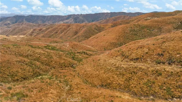 a view of a mountain range in a cloudy sky